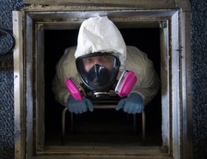 a professional pest control in a hazmat suit